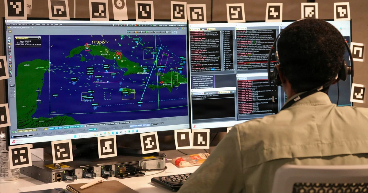 A U.S. Airman wearing a headset works at two computer displays during a Decision Advantage Sprint for Human-Machine Teaming experiment in Las Vegas. U.S. Air Force photo by Debora Henley.